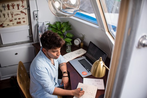 man sitting at desk with computer